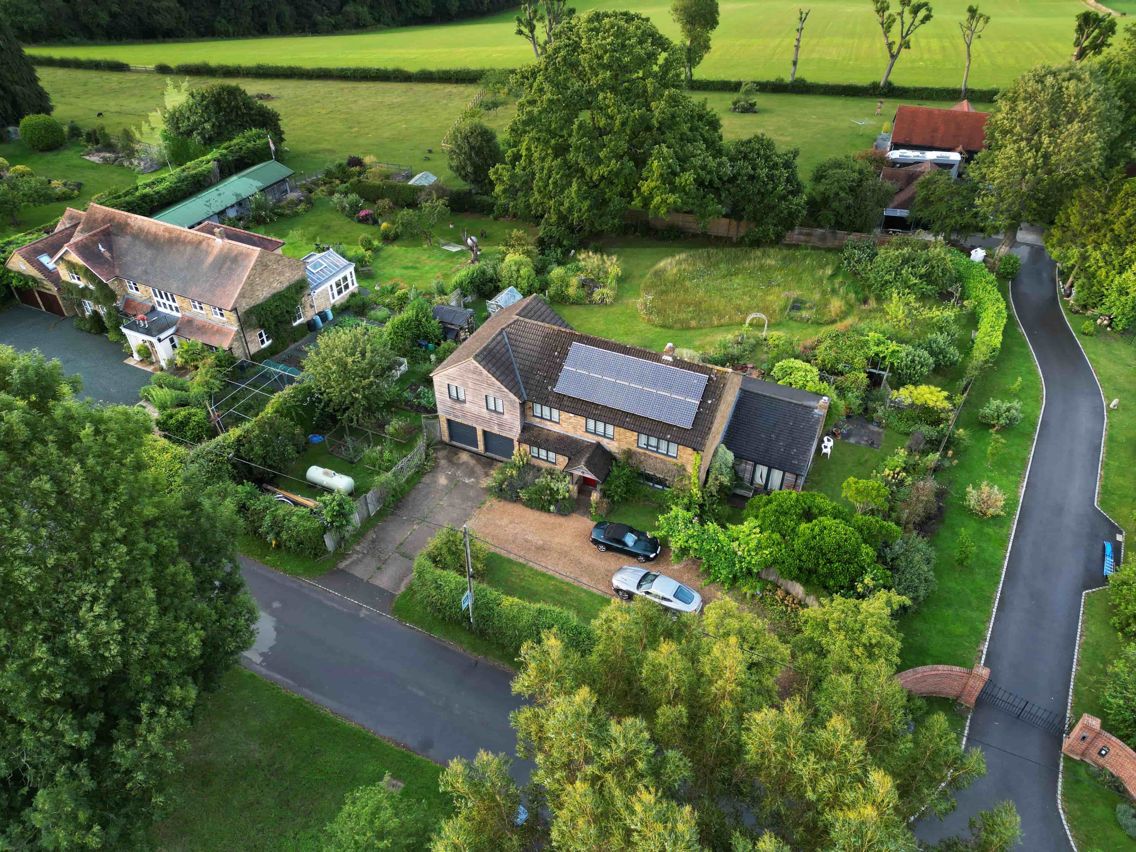 An elevated top down drone shot for a property listing in Radnage that reveals a gorgeous green garden and surrounding